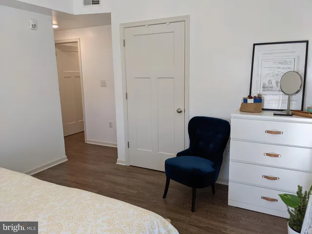 a view of a workspace with furniture and a potted plant