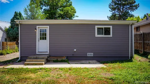 a view of a room with wooden floor and windows
