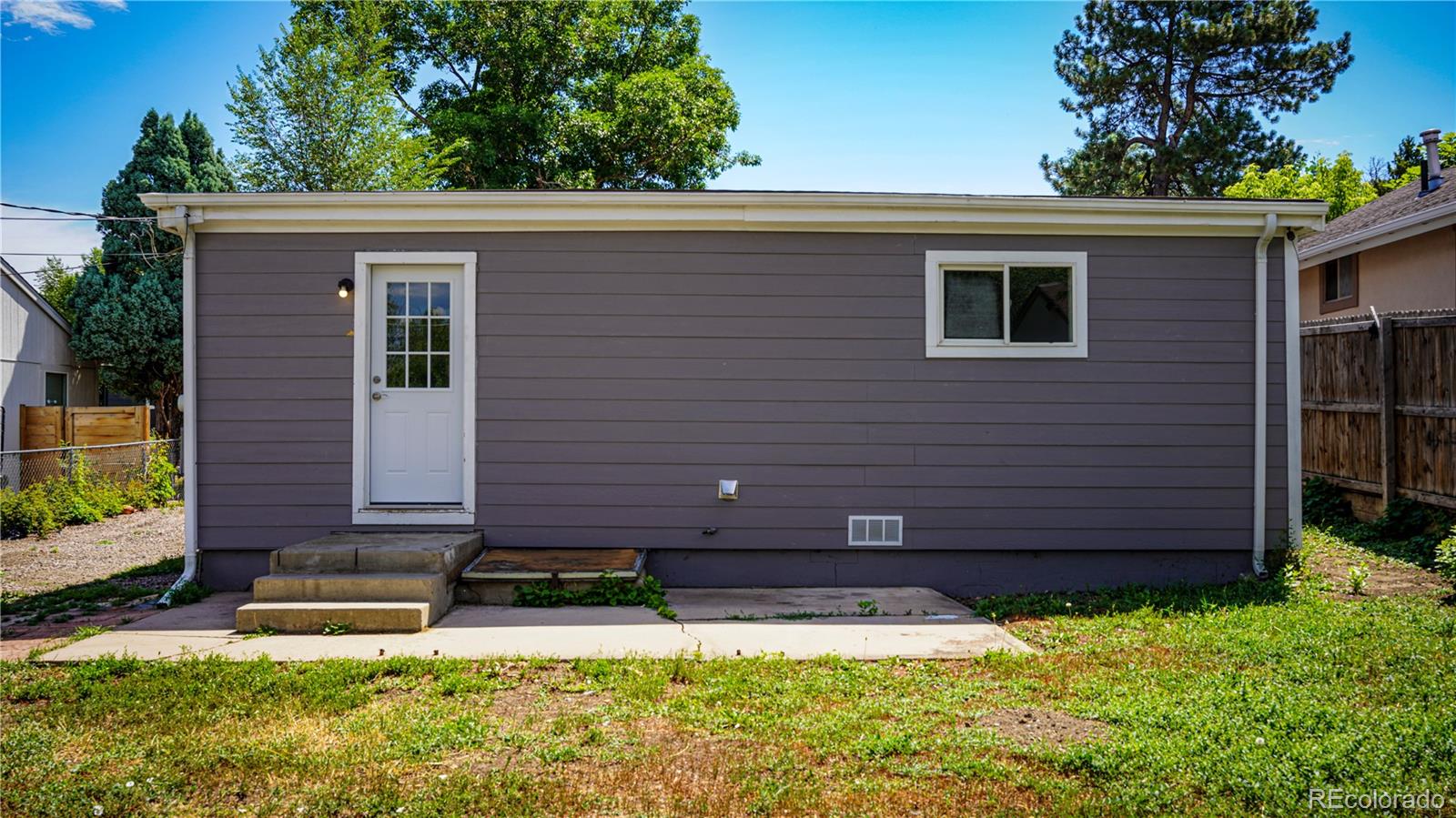 909 Meade Street Denver, CO 80204 - Photo 11 of 15 a front view of a house with a yard