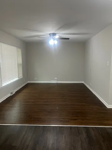 a view of room with window and wooden floor