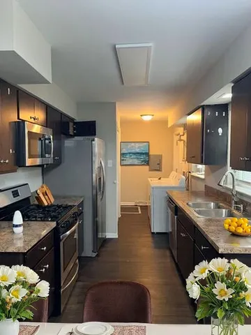 a kitchen with refrigerator and cabinets