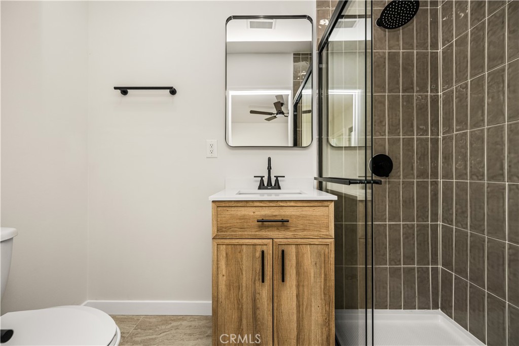 1013 West 138th Street Compton, CA 90222 - Photo 24 of 30 a bathroom with a shower a sink and toilet
