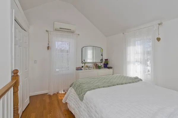 a bedroom with a bed and a mirror