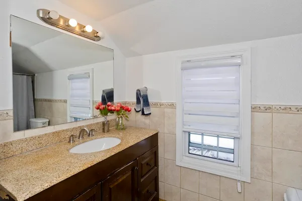 a bathroom with a sink double vanity and a mirror