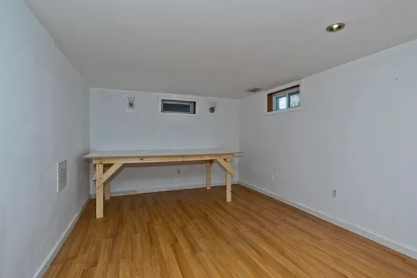 a room with wooden floor and furniture