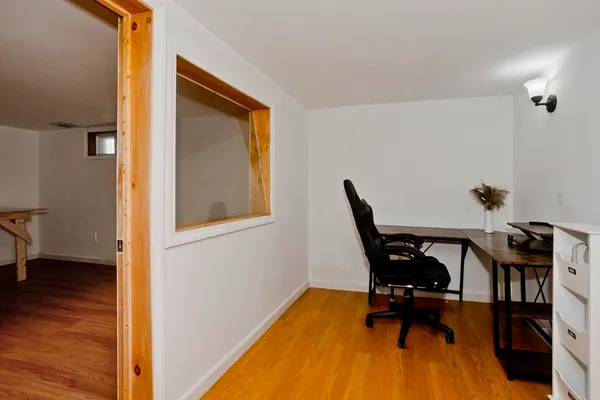 a view of workspace with wooden floor and chair