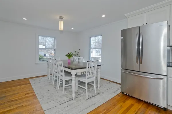 a view of a dining room with furniture window and wooden floor