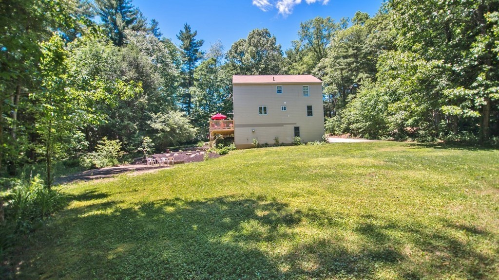 125 Bond Road Charlton, MA 01507 - Photo 24 of 29 a view of a house with a yard and garage