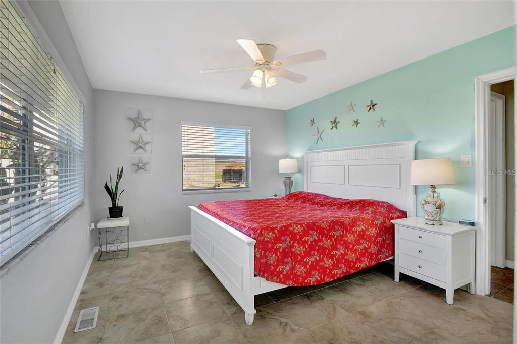 250 Bangsberg Road Southeast Port Charlotte, FL 33952 - Photo 13 of 59 a bedroom with a bed and window
