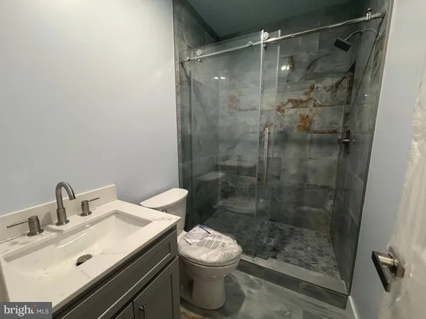 a open kitchen with kitchen island a sink stainless steel appliances and cabinets