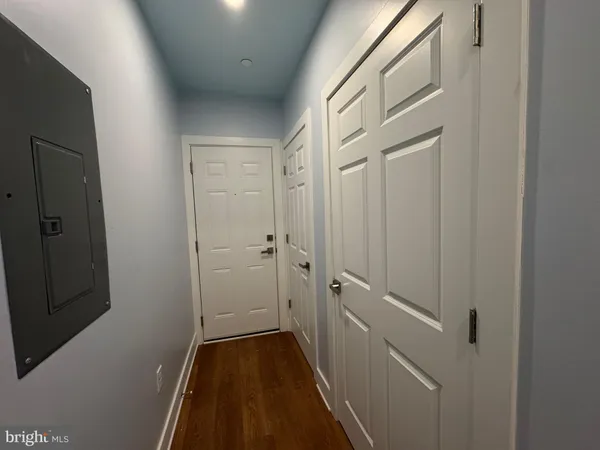 a view of empty room with wooden floor