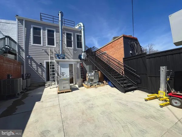 a view of a brick house with a small yard