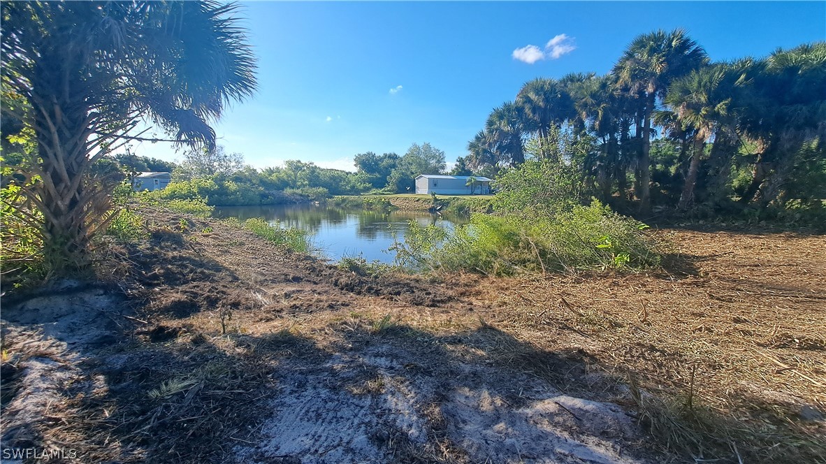 Derby Lane Moore Haven, FL 33471 - Photo 2 of 20 a view of a lake with a yard