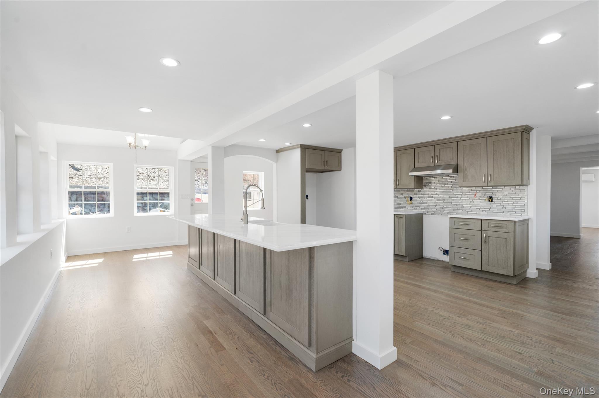 70 Barmore Road LaGrangeville, NY 12540 - Photo 11 of 47 Kitchen with under cabinet range hood, a chandelier, light wood-style floors, tasteful backsplash, and recessed lighting
