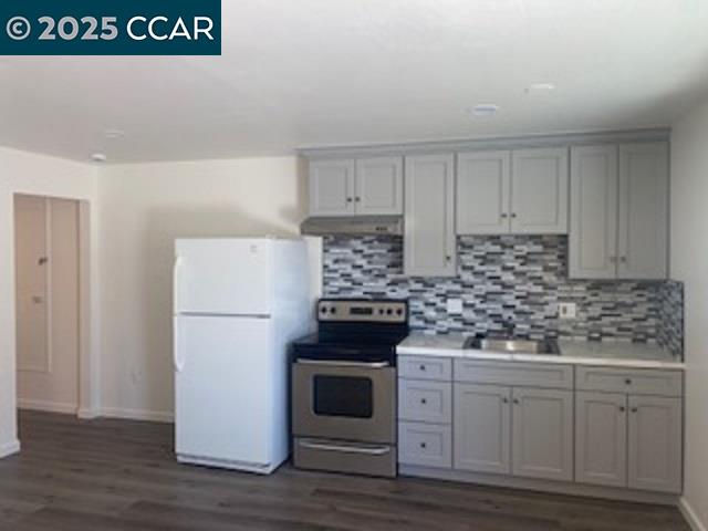 527 Vaqueros Avenue, Unit C Rodeo, CA 94572 - Photo 2 of 9 a kitchen with granite countertop white cabinets and white appliances