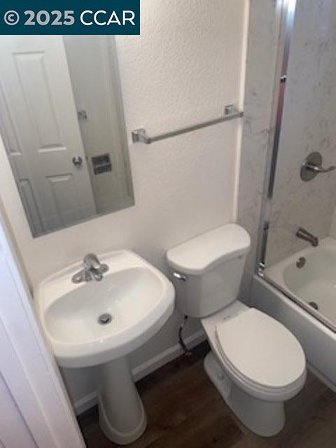 527 Vaqueros Avenue, Unit C Rodeo, CA 94572 - Photo 7 of 9 a white toilet sitting next to a bathroom sink