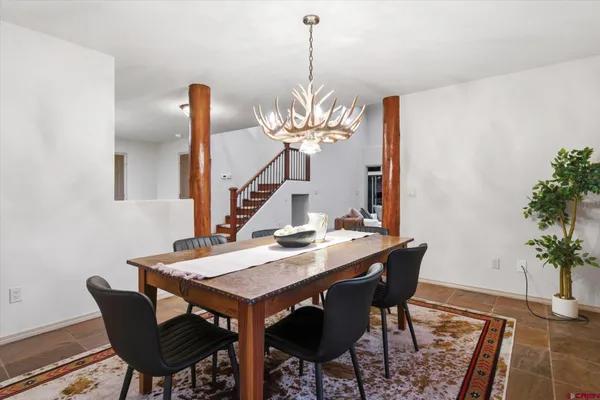 a dining room with a table and chairs