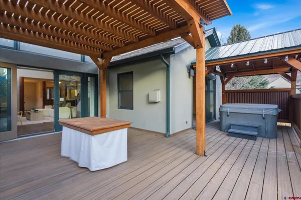 a bedroom with a bed next to a window with a chandelier