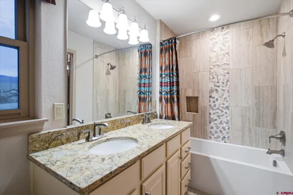 a view of a terrace with furniture and a garden