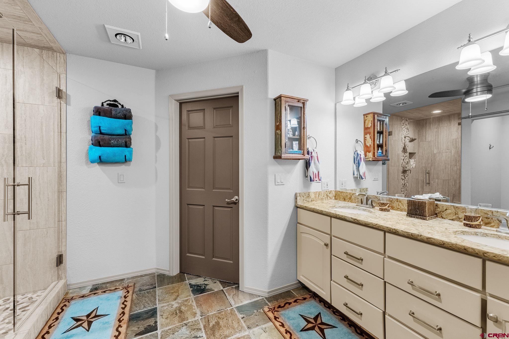 243 Cypress Court Durango, CO 81301 - Photo 24 of 42 a spacious bathroom with a sink and a mirror