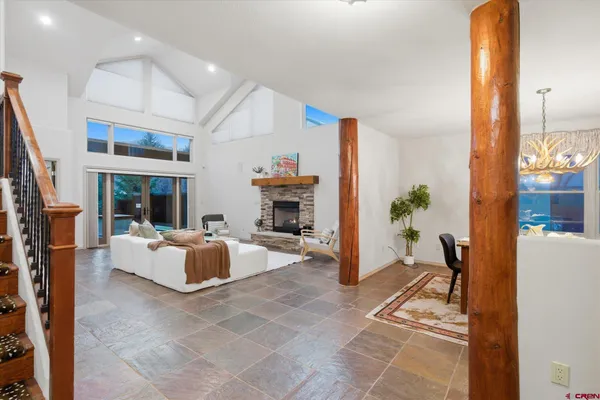 a living room with furniture a fireplace and a potted plant