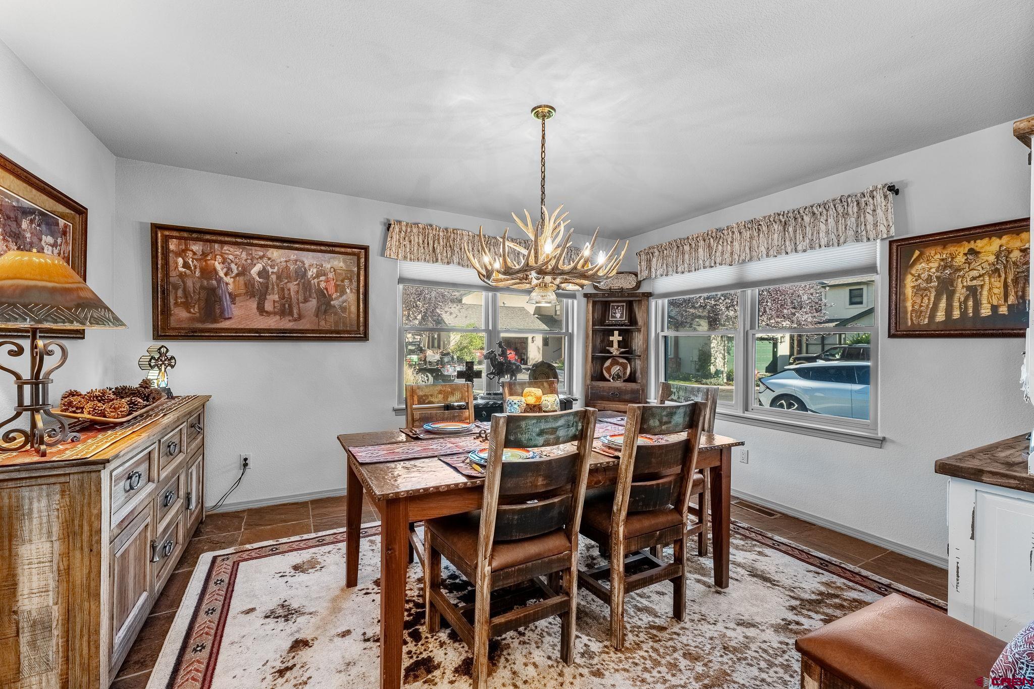 243 Cypress Court Durango, CO 81301 - Photo 5 of 42 a view of a dining room with furniture window and wooden floor
