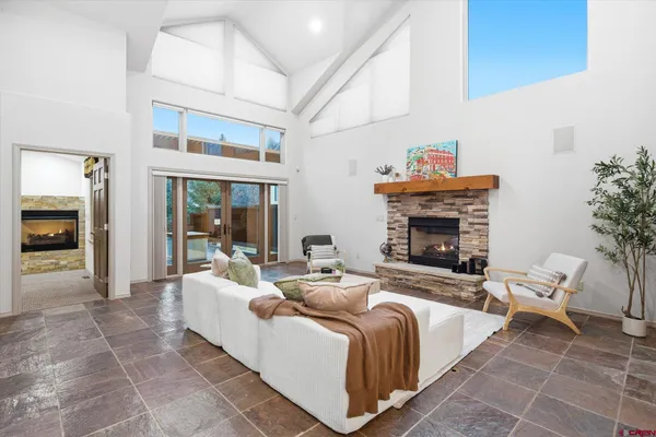 a living room with furniture and a chandelier