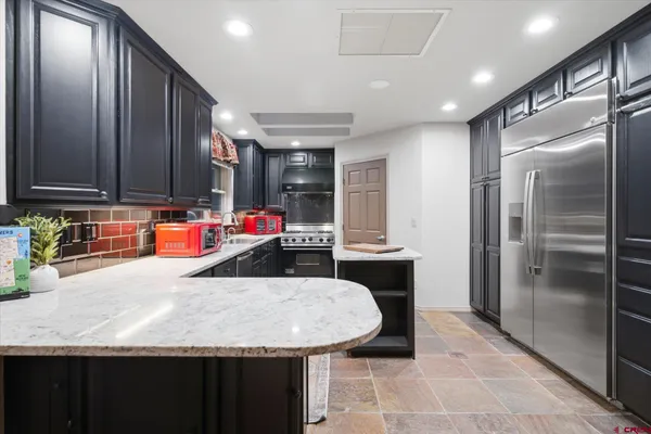 a kitchen with counter top space and appliances