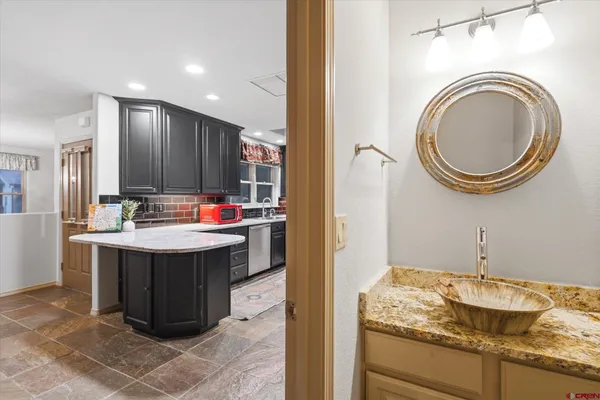 a kitchen with stainless steel appliances granite countertop a sink stove and cabinets