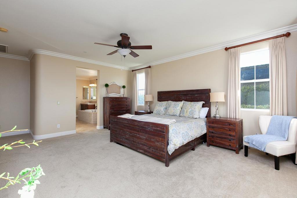 7231 Ocotillo Street Santee, CA 92071 - Photo 19 of 59 a spacious bedroom with a bed and a couch