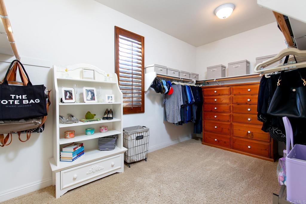 7231 Ocotillo Street Santee, CA 92071 - Photo 21 of 59 a view of walk in closet with clothes and shoes