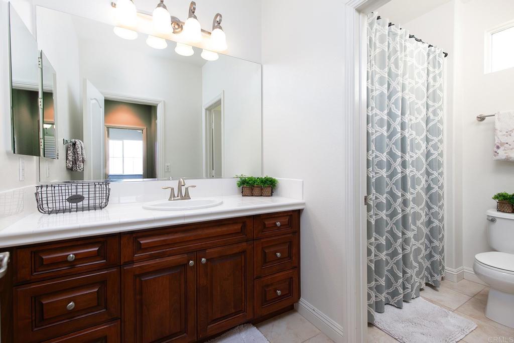 7231 Ocotillo Street Santee, CA 92071 - Photo 37 of 59 a bathroom with a sink a toilet and a mirror