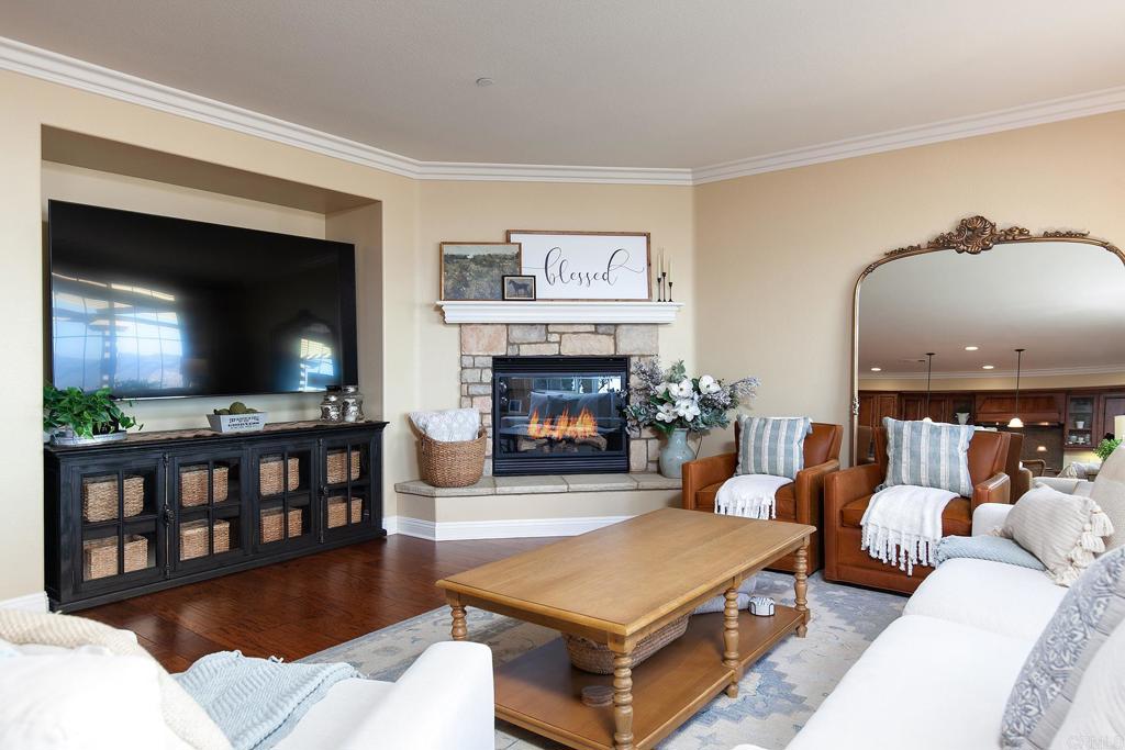 7231 Ocotillo Street Santee, CA 92071 - Photo 7 of 59 a living room with furniture a flat screen tv and a fireplace