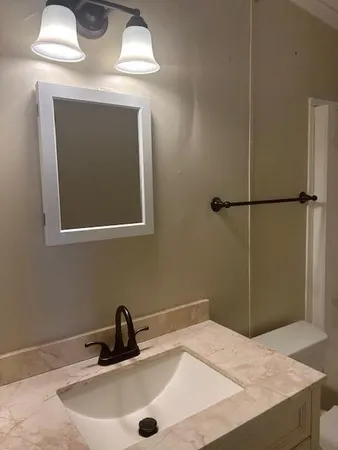 a bathroom with a sink and mirror