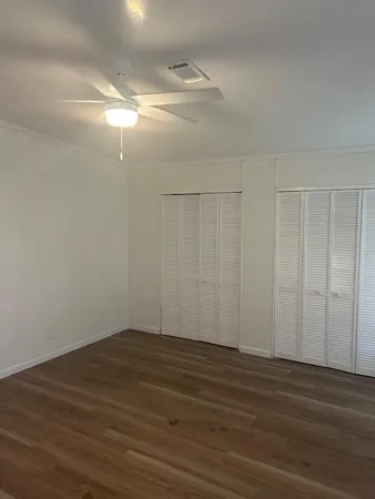 a view of a room with wooden floor