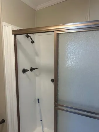 a bathroom with a glass shower door