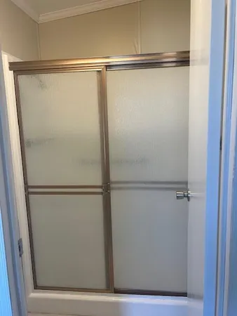 a bathroom with a glass shower door