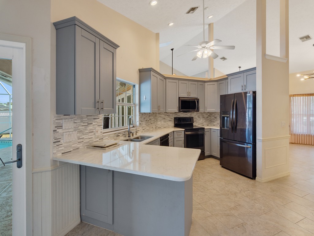470 10th Place Southwest Vero Beach, FL 32962 - Photo 12 of 36 a large kitchen with cabinets stainless steel appliances and a counter top