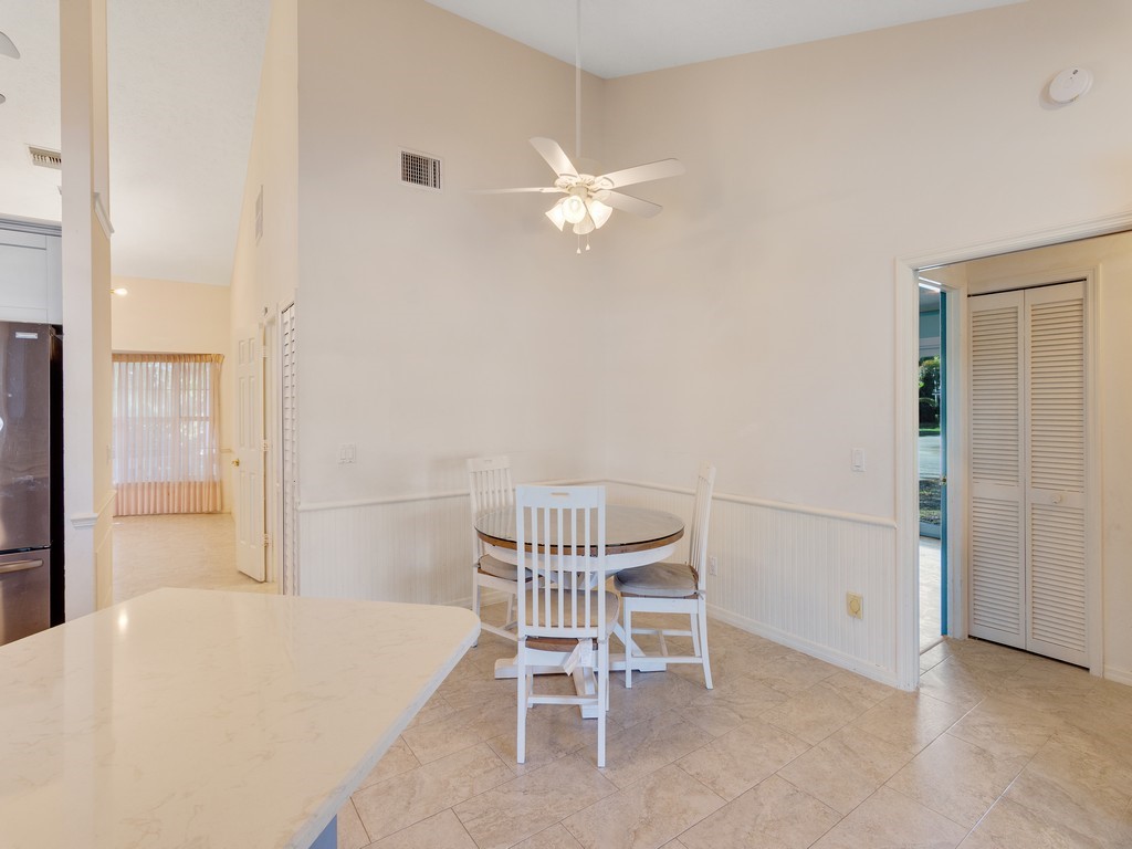 470 10th Place Southwest Vero Beach, FL 32962 - Photo 13 of 36 a dining room with furniture and a chandelier fan