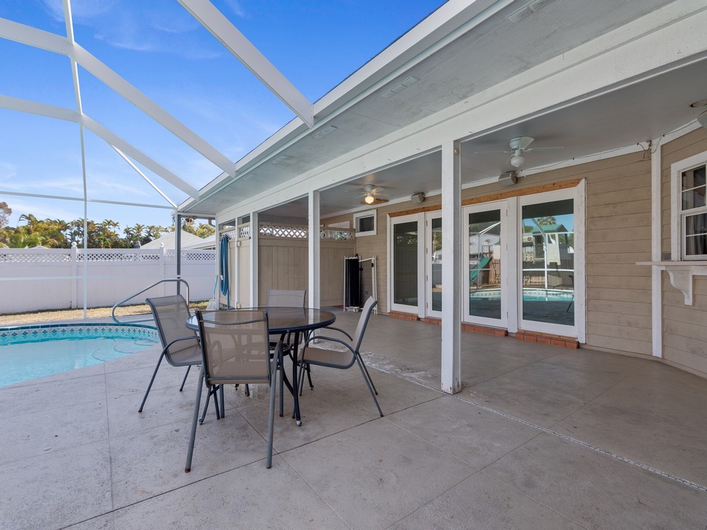 470 10th Place Southwest Vero Beach, FL 32962 - Photo 28 of 36 a view of a patio with table and chairs and potted plants