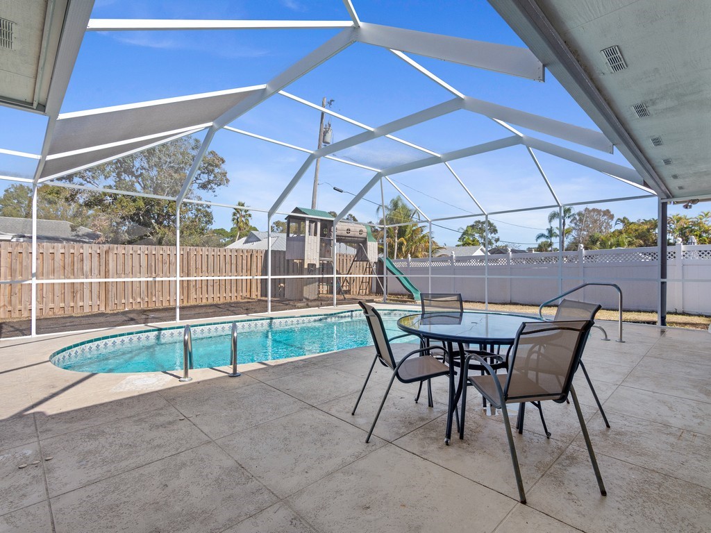 470 10th Place Southwest Vero Beach, FL 32962 - Photo 29 of 36 a view of a backyard with table and chairs under an umbrella