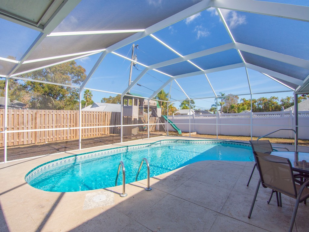 470 10th Place Southwest Vero Beach, FL 32962 - Photo 31 of 36 a view of a backyard with table and chairs under an umbrella