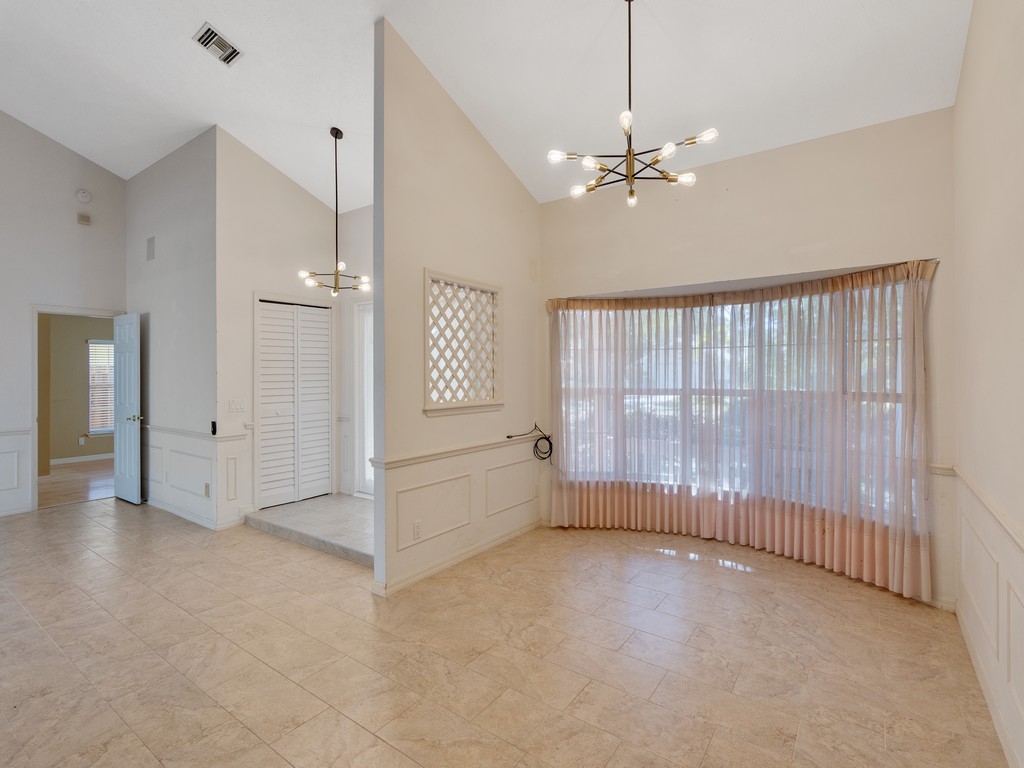 470 10th Place Southwest Vero Beach, FL 32962 - Photo 9 of 36 an empty room with chandelier fan and windows