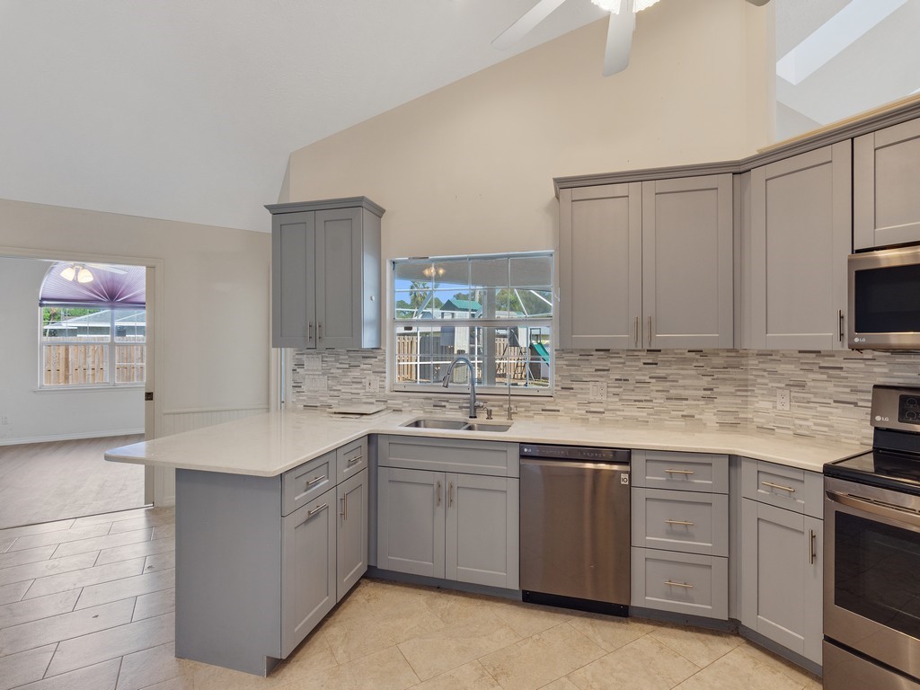 470 10th Place Southwest Vero Beach, FL 32962 - Photo 10 of 36 a kitchen with a sink stove and cabinets