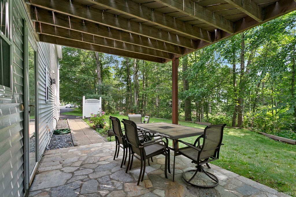 6 Stonegate Lane Shelton, CT 06484 - Photo 29 of 37 a view of a patio with table and chairs and potted plants