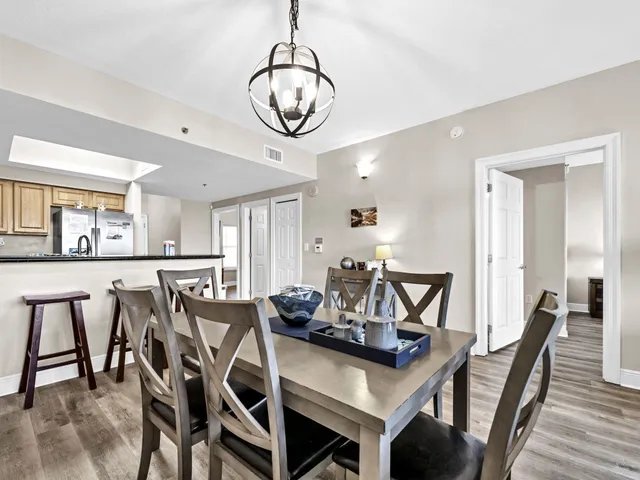 a view of a dining room with furniture and a chandelier