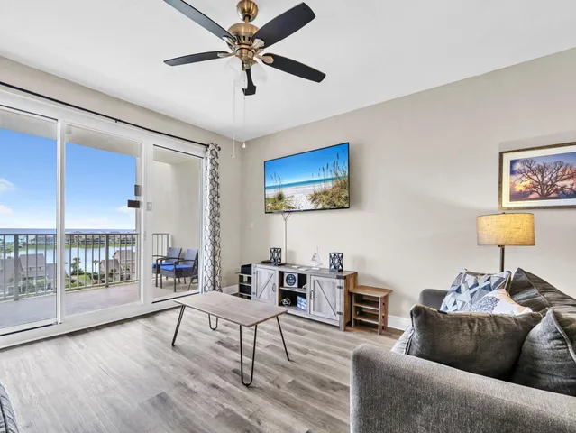 a living room with furniture and a ceiling fan