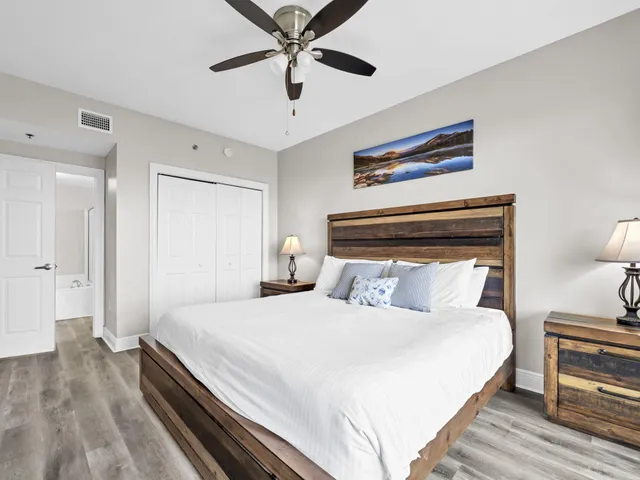 a bedroom with a large bed and a chandelier