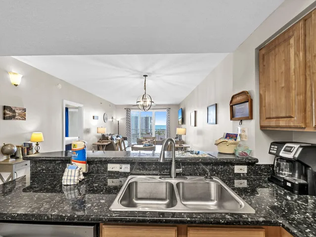 a kitchen with sink a faucet cabinets and appliances