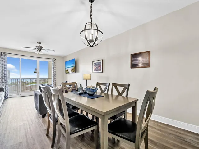 a view of a dining room with furniture wooden floor and chandelier